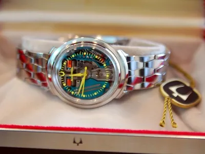 Silver wristwatch with colorful face and box.