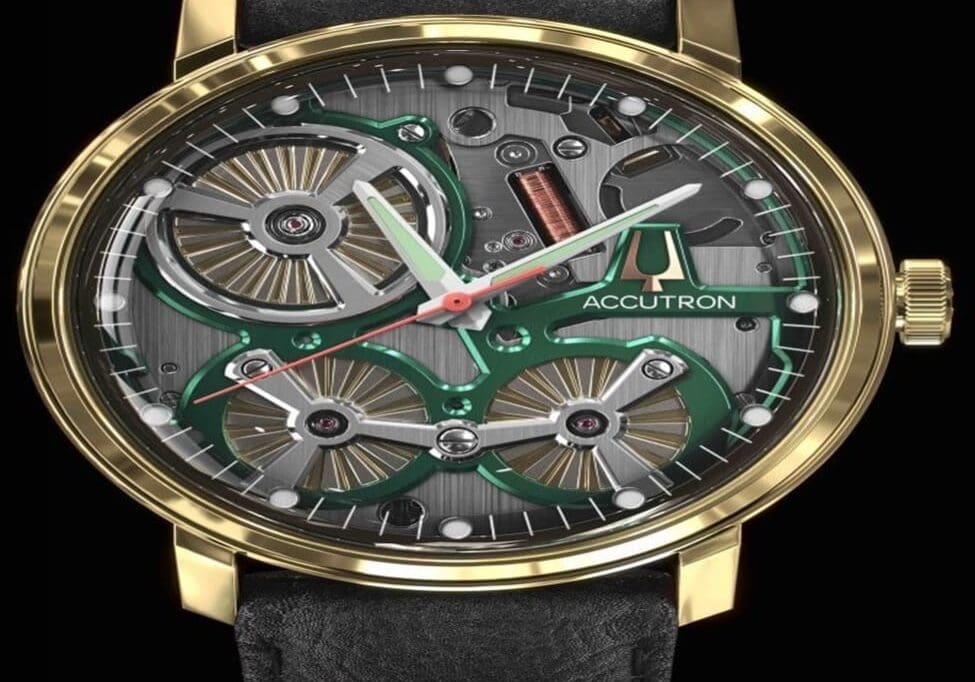 Accutron gold watch with green accents.