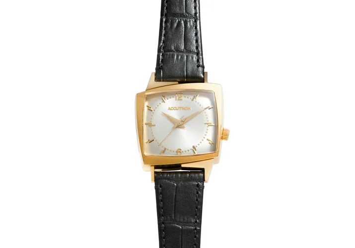 Gold Accutron watch with black band.